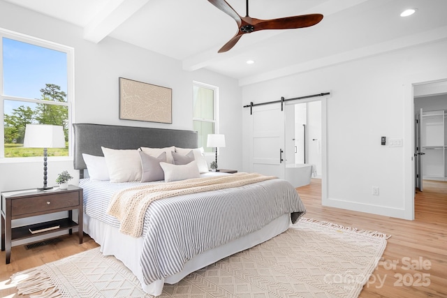 104 Arbor Dr, Waxhaw, NC 28173 - bedroom with beamed ceiling, a barn door, wood finished floors, recessed lighting, and ceiling fan