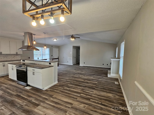 7154 Woodcock Trl, Stanley, NC 28164 - kitchen with island exhaust hood, stainless steel electric range, dark wood-type flooring, a textured ceiling, and open floor plan
