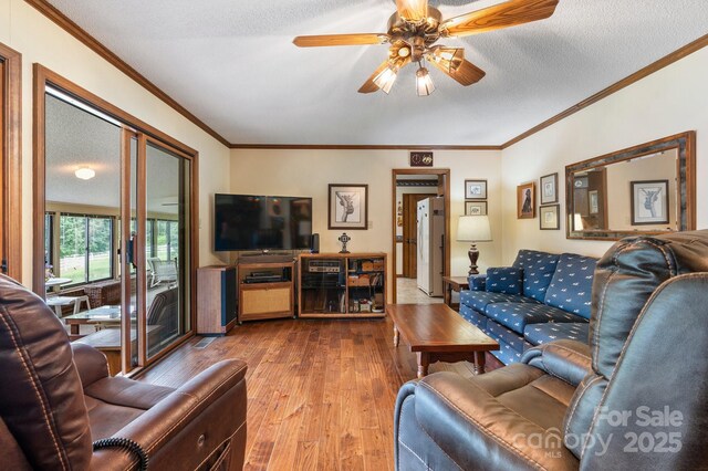 2448 Moss Farm Rd, Hickory, NC 28602 - living room with hardwood / wood-style flooring, a ceiling fan, ornamental molding, and a textured ceiling
