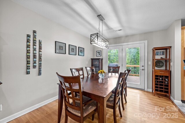 931 Indian Hill Rd, Hendersonville, NC 28791 - dining space featuring light wood finished floors, baseboards, and a chandelier