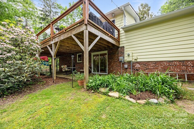 931 Indian Hill Rd, Hendersonville, NC 28791 - back of house with a deck, brick siding, and a lawn