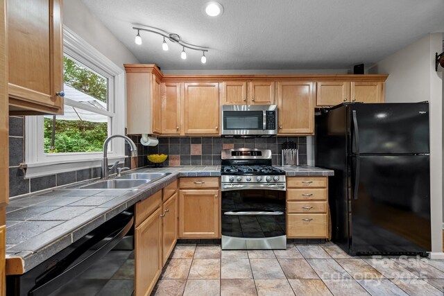 931 Indian Hill Rd, Hendersonville, NC 28791 - kitchen featuring black appliances, tile counters, a sink, and decorative backsplash