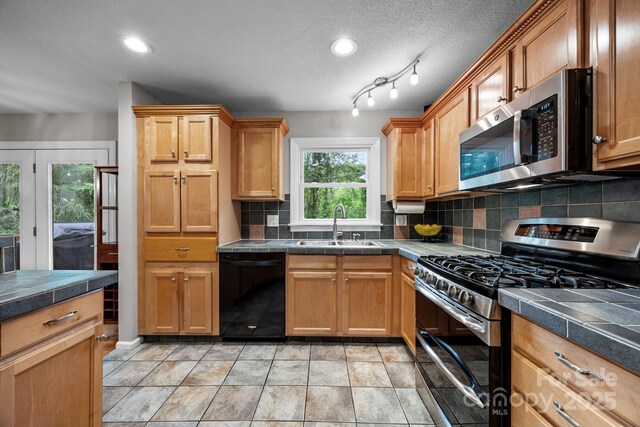 931 Indian Hill Rd, Hendersonville, NC 28791 - kitchen featuring appliances with stainless steel finishes, tile countertops, decorative backsplash, a sink, and recessed lighting