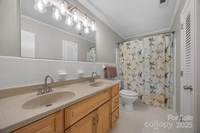 931 Indian Hill Rd, Hendersonville, NC 28791 - bathroom featuring crown molding, tile walls, double vanity, toilet, and tile patterned flooring