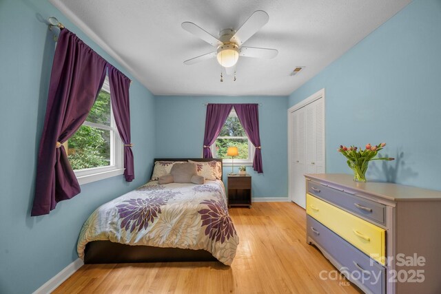 931 Indian Hill Rd, Hendersonville, NC 28791 - bedroom featuring a closet, light wood-style flooring, baseboards, and ceiling fan