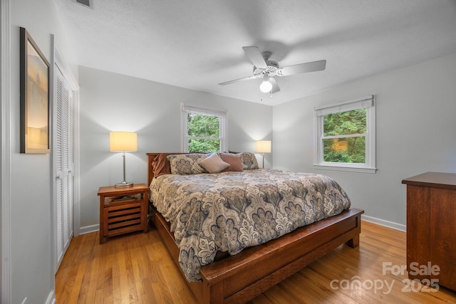 931 Indian Hill Rd, Hendersonville, NC 28791 - bedroom with a closet, light wood-style floors, baseboards, and ceiling fan