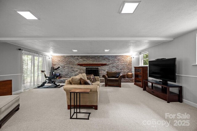 931 Indian Hill Rd, Hendersonville, NC 28791 - carpeted living room featuring a fireplace, brick wall, baseboards, and a textured ceiling