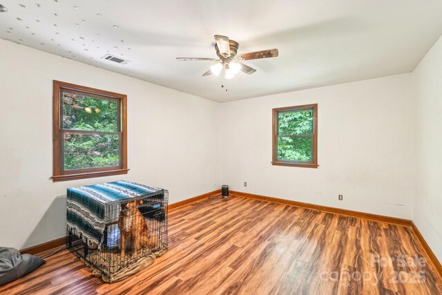 8504 Knollwood Cir, Charlotte, NC 28213 - unfurnished room with baseboards, wood finished floors, and a ceiling fan