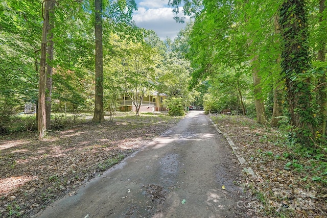 8504 Knollwood Cir, Charlotte, NC 28213 - view of asphalt driveway featuring a forest view