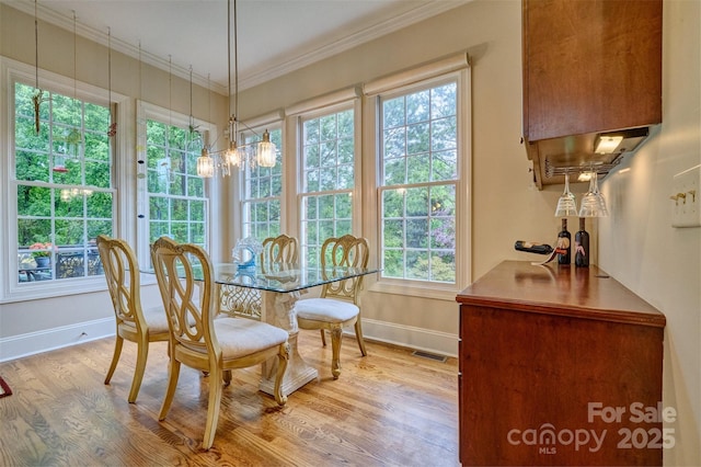 5826 Natoma Rd, Lake Wylie, SC 29710 - dining room featuring wood finished floors and ornamental molding