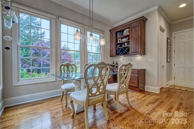 5826 Natoma Rd, Lake Wylie, SC 29710 - dining area featuring healthy amount of natural light, crown molding, light wood-style floors, a chandelier, and recessed lighting