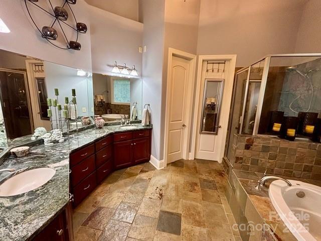 5826 Natoma Rd, Lake Wylie, SC 29710 - full bath with a bath, a shower stall, a towering ceiling, double vanity, and stone tile flooring