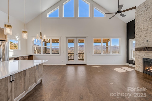 203 Boleyn Dr, Black Mountain, NC 28711 - unfurnished living room featuring high vaulted ceiling, ceiling fan, a stone fireplace, dark wood-type flooring, and baseboards