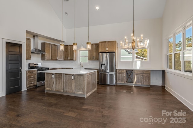 203 Boleyn Dr, Black Mountain, NC 28711 - kitchen featuring stainless steel appliances, wall chimney range hood, high vaulted ceiling, a chandelier, and a sink