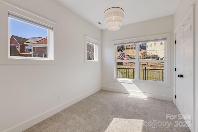 203 Boleyn Dr, Black Mountain, NC 28711 - empty room with carpet, healthy amount of natural light, a chandelier, and baseboards