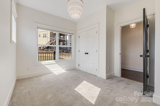 203 Boleyn Dr, Black Mountain, NC 28711 - unfurnished bedroom with carpet, a chandelier, a closet, and baseboards