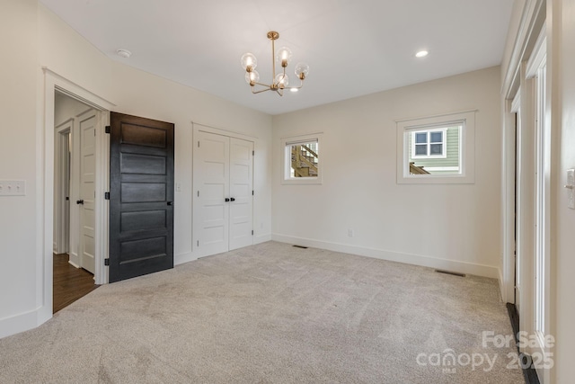 203 Boleyn Dr, Black Mountain, NC 28711 - unfurnished bedroom featuring carpet floors, a chandelier, baseboards, and a closet