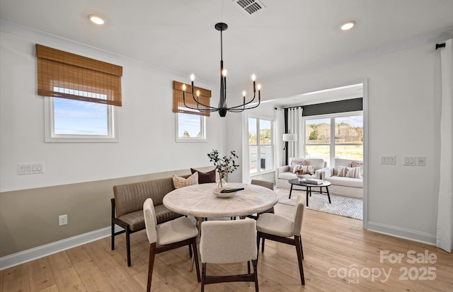 dining area featuring baseboards, a chandelier, light wood finished floors, ornamental molding, and recessed lighting