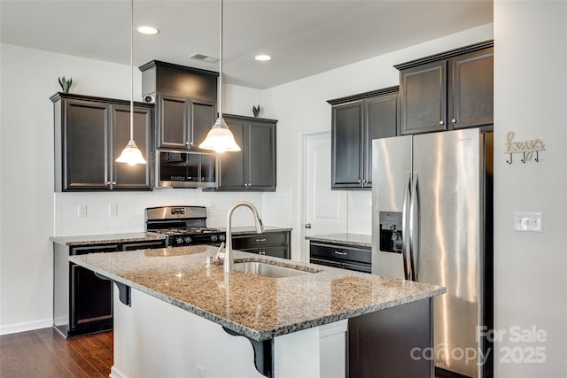 1553 Arcadia Bluff Dr, York, SC 29745 - kitchen featuring appliances with stainless steel finishes, a sink, light stone countertops, dark wood-type flooring, and backsplash