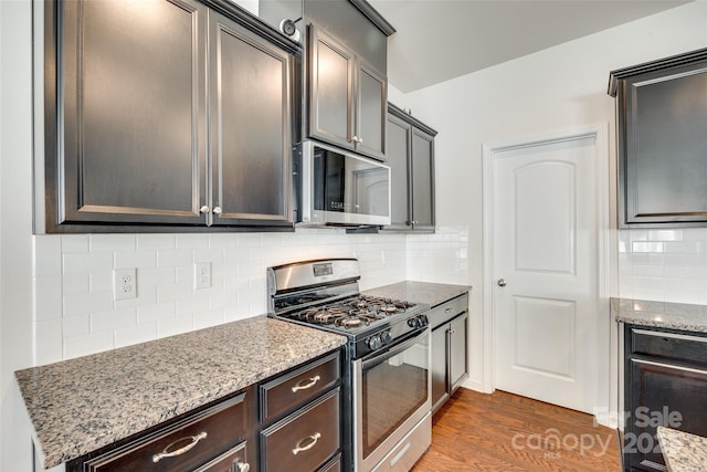 1553 Arcadia Bluff Dr, York, SC 29745 - kitchen with stainless steel appliances, light stone counters, dark wood-type flooring, and decorative backsplash