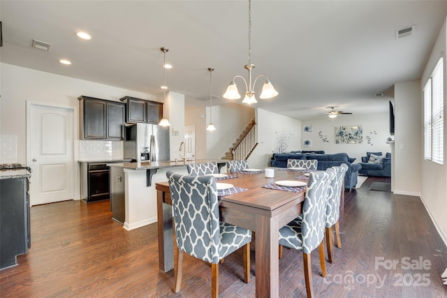 1553 Arcadia Bluff Dr, York, SC 29745 - dining room featuring stairs, recessed lighting, dark wood-type flooring, ceiling fan, and a chandelier