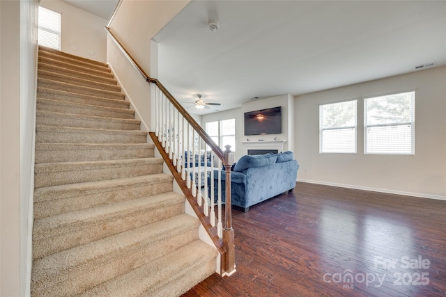 1553 Arcadia Bluff Dr, York, SC 29745 - stairs featuring wood finished floors, a ceiling fan, a fireplace, and baseboards