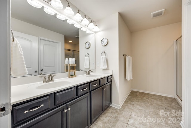 1553 Arcadia Bluff Dr, York, SC 29745 - full bathroom featuring double vanity, baseboards, an enclosed shower, and tile patterned flooring
