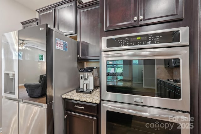 5812 Dinsmore Ln, Belmont, NC 28012 - kitchen featuring stainless steel appliances, dark brown cabinets, decorative backsplash, ceiling fan, and light stone countertops