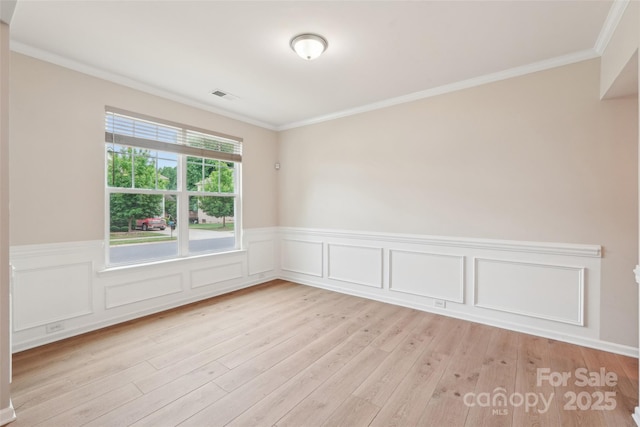 5812 Dinsmore Ln, Belmont, NC 28012 - spare room featuring wainscoting, light wood-style flooring, and crown molding