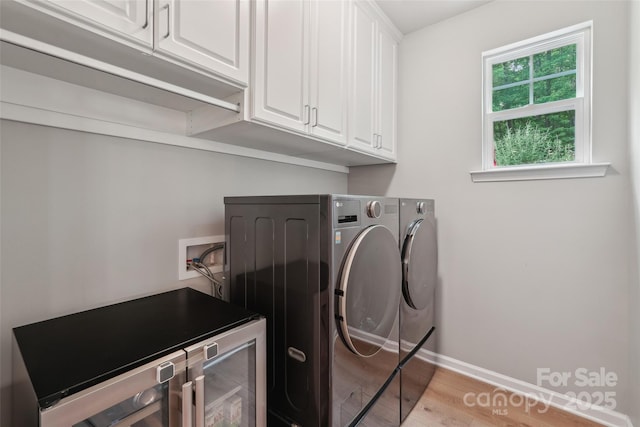 5812 Dinsmore Ln, Belmont, NC 28012 - laundry area with cabinet space, washer and clothes dryer, light wood finished floors, baseboards, and beverage cooler