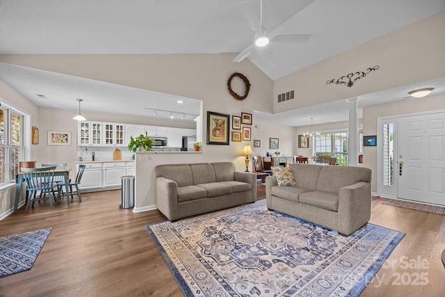 296 Planters Creek Rd, Fletcher, NC 28732 - living room featuring ornate columns, wood finished floors, lofted ceiling, and ceiling fan