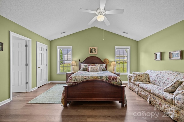 296 Planters Creek Rd, Fletcher, NC 28732 - bedroom with wood finished floors, lofted ceiling, a textured ceiling, and baseboards