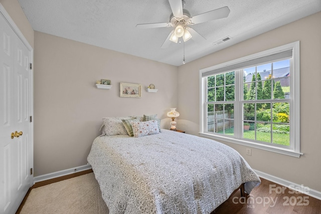 296 Planters Creek Rd, Fletcher, NC 28732 - bedroom featuring baseboards, wood finished floors, ceiling fan, and a textured ceiling