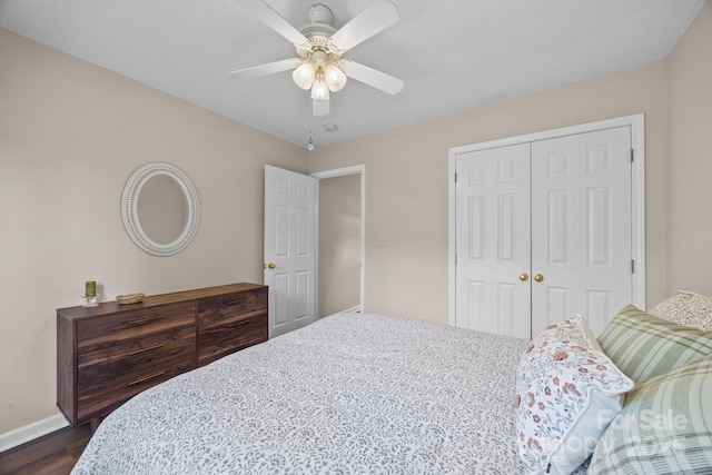 296 Planters Creek Rd, Fletcher, NC 28732 - bedroom featuring a closet, baseboards, dark wood-style flooring, and a ceiling fan