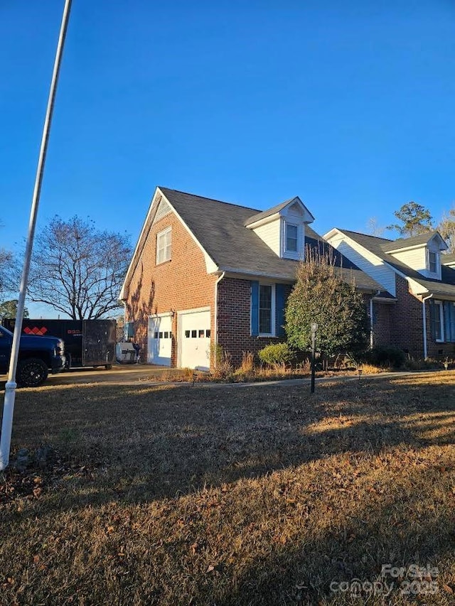 100 Boros Lndg, New Bern, NC 28560 - view of property exterior with an attached garage, brick siding, and a yard