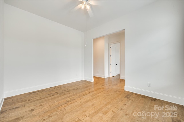 empty room with ceiling fan, baseboards, and light wood-style flooring