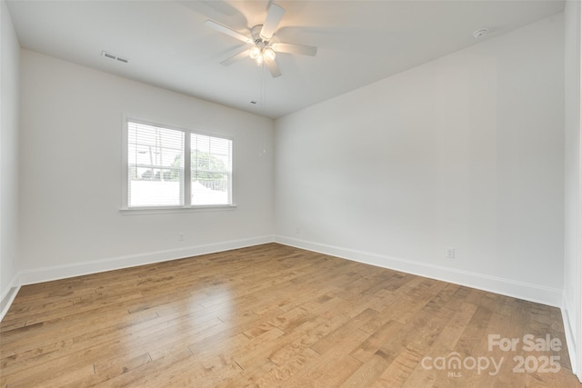 empty room with light wood-style flooring, baseboards, and a ceiling fan