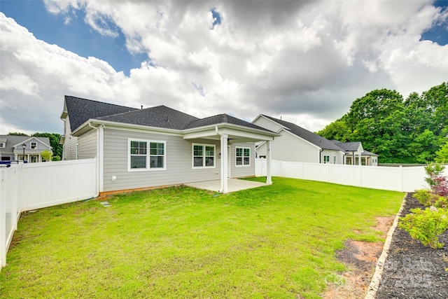back of house featuring a patio area and roof with shingles