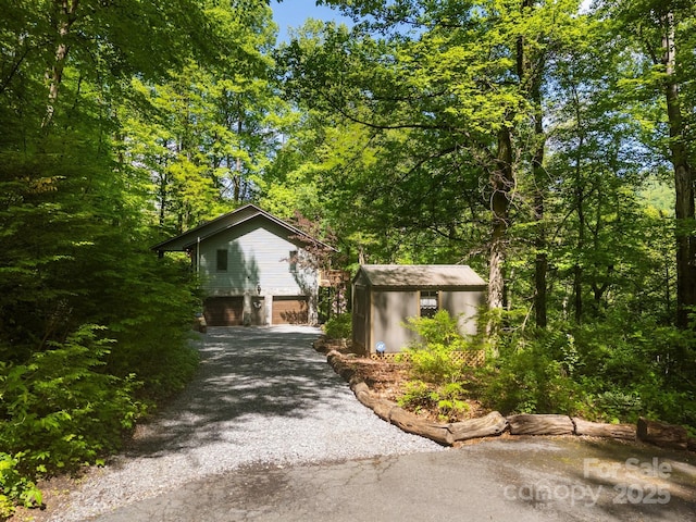 81 Corbin Shady Ln, Waynesville, NC 28785 - view of front of property with driveway, a garage, a storage shed, and an outdoor structure