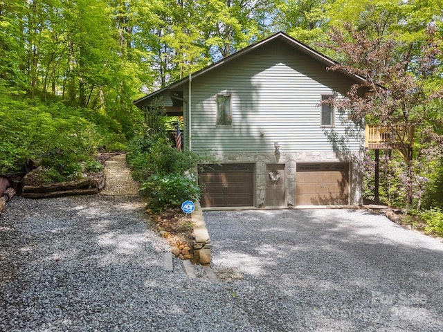 81 Corbin Shady Ln, Waynesville, NC 28785 - view of side of property with an attached garage, stone siding, and driveway