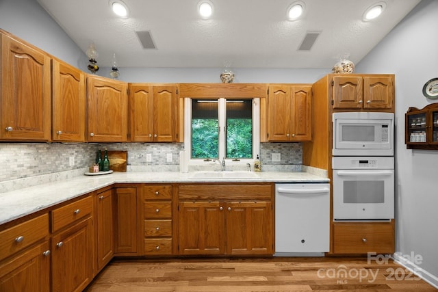 81 Corbin Shady Ln, Waynesville, NC 28785 - kitchen featuring white appliances, a sink, decorative backsplash, and light wood-style floors