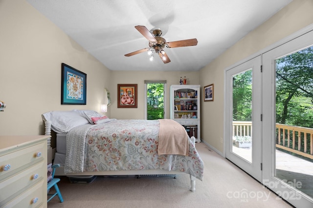 81 Corbin Shady Ln, Waynesville, NC 28785 - bedroom featuring multiple windows, access to outside, light colored carpet, and a ceiling fan