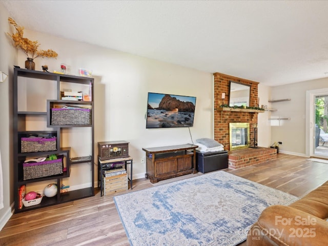 11718 Battery Pl, Charlotte, NC 28273 - living room featuring wood finished floors, a fireplace, and baseboards