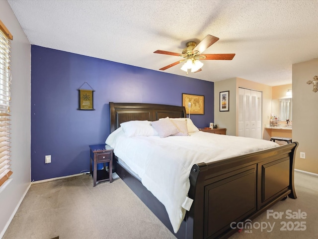 11718 Battery Pl, Charlotte, NC 28273 - bedroom with a closet, light colored carpet, baseboards, a textured ceiling, and a ceiling fan