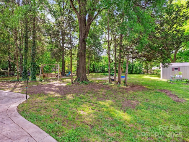 11718 Battery Pl, Charlotte, NC 28273 - view of green lawn with a playground and an outbuilding