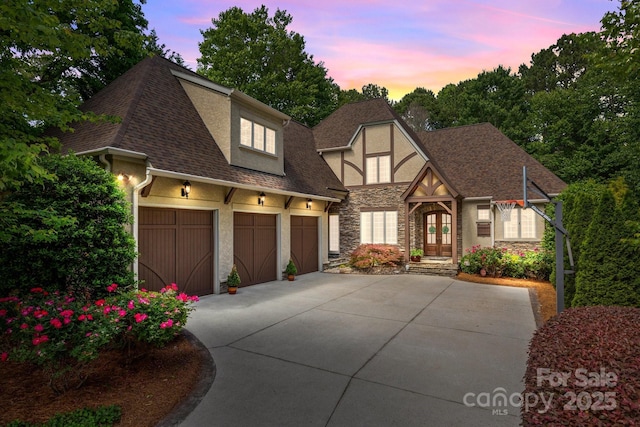 104 Golden Bell Ct, Mooresville, NC 28117 - view of front of house featuring stone siding, concrete driveway, stucco siding, and a shingled roof