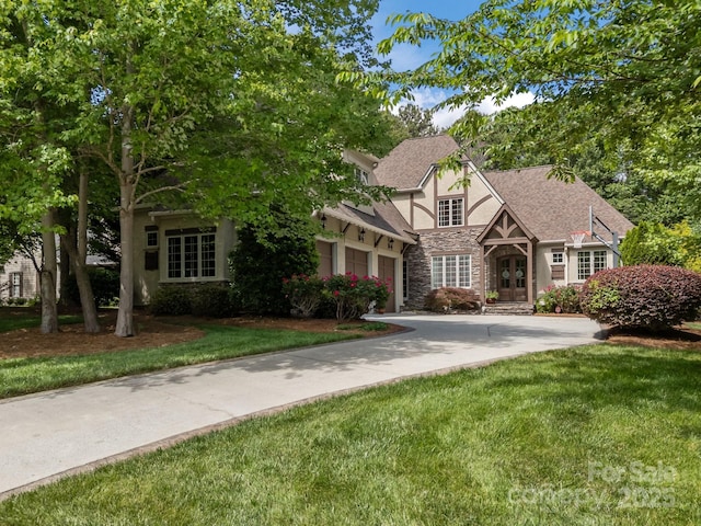 104 Golden Bell Ct, Mooresville, NC 28117 - tudor house with stone siding, stucco siding, a front lawn, and driveway
