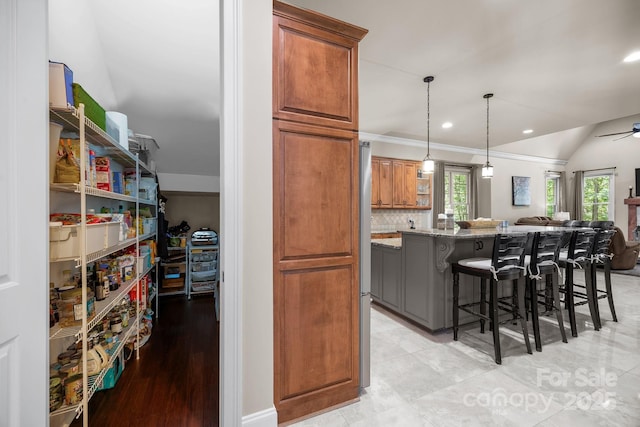 104 Golden Bell Ct, Mooresville, NC 28117 - kitchen featuring light stone countertops, a breakfast bar, brown cabinets, backsplash, and recessed lighting
