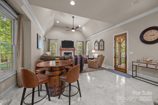 104 Golden Bell Ct, Mooresville, NC 28117 - dining space featuring baseboards, ceiling fan, a glass covered fireplace, vaulted ceiling, and recessed lighting