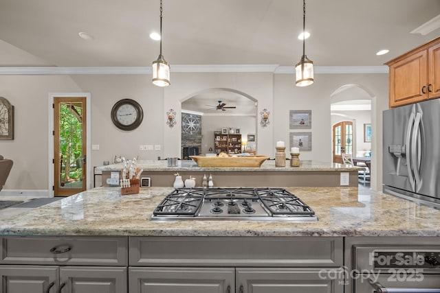 104 Golden Bell Ct, Mooresville, NC 28117 - kitchen with arched walkways, a ceiling fan, gray cabinets, appliances with stainless steel finishes, and ornamental molding